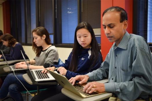 Katherine Young (center), a sophomore enrolled in 6.S04 (Fundamentals of Programming), works with Professor Srini Devadas on one of the class's software labs. 