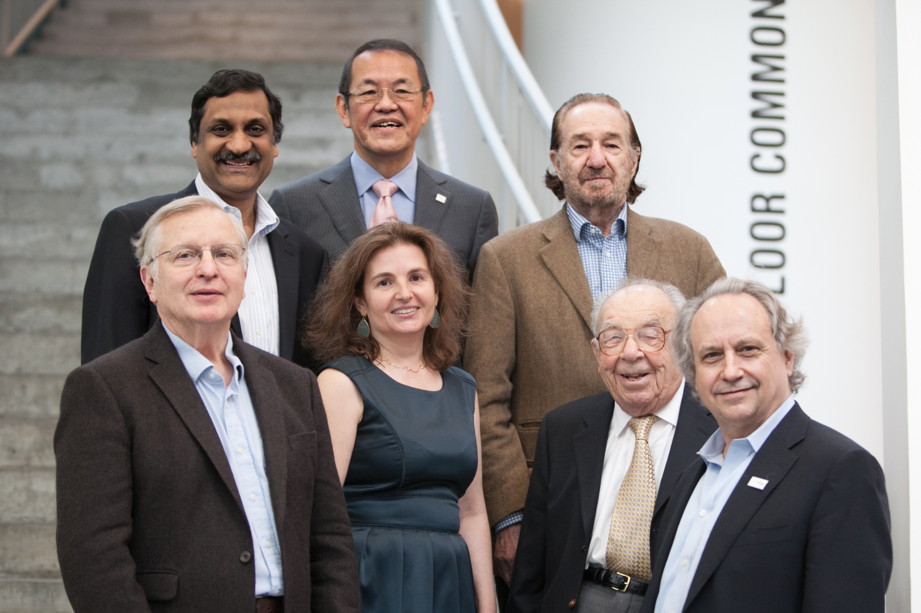 Group shot of CSAIL's former and current faculty directors standing together on a white staircase from 2013. 