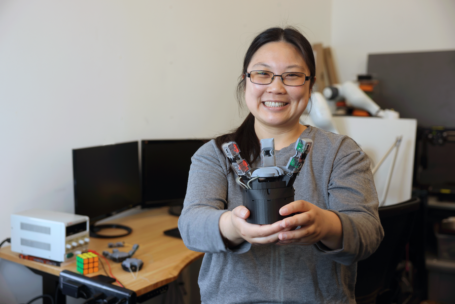 MIT CSAIL student Sandra Q. Liu displays her innovative GelPalm robotic design in her lab workspace (Credits: Michael Grimmett/MIT CSAIL).