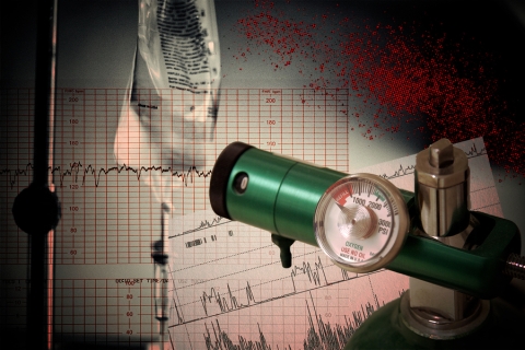 An oxygen meter in front of an IV bag and various medical read-outs