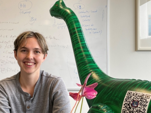 Kelsey Merrill with the legendary Vote-a-Saurus at the PKG Public Service Center Office (Credits: The PKG Public Service Center).